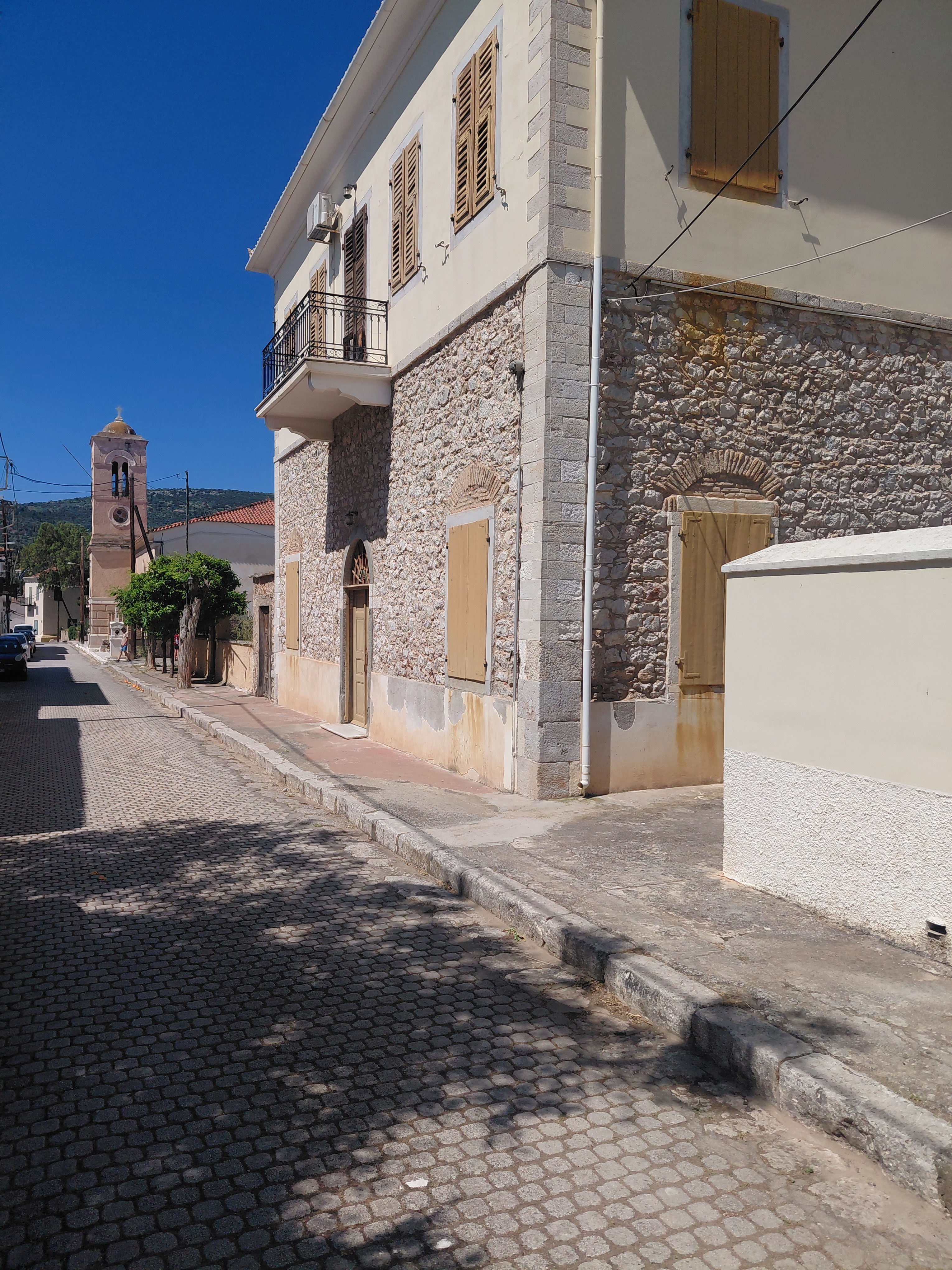 The mansion above the town with the sea beyond